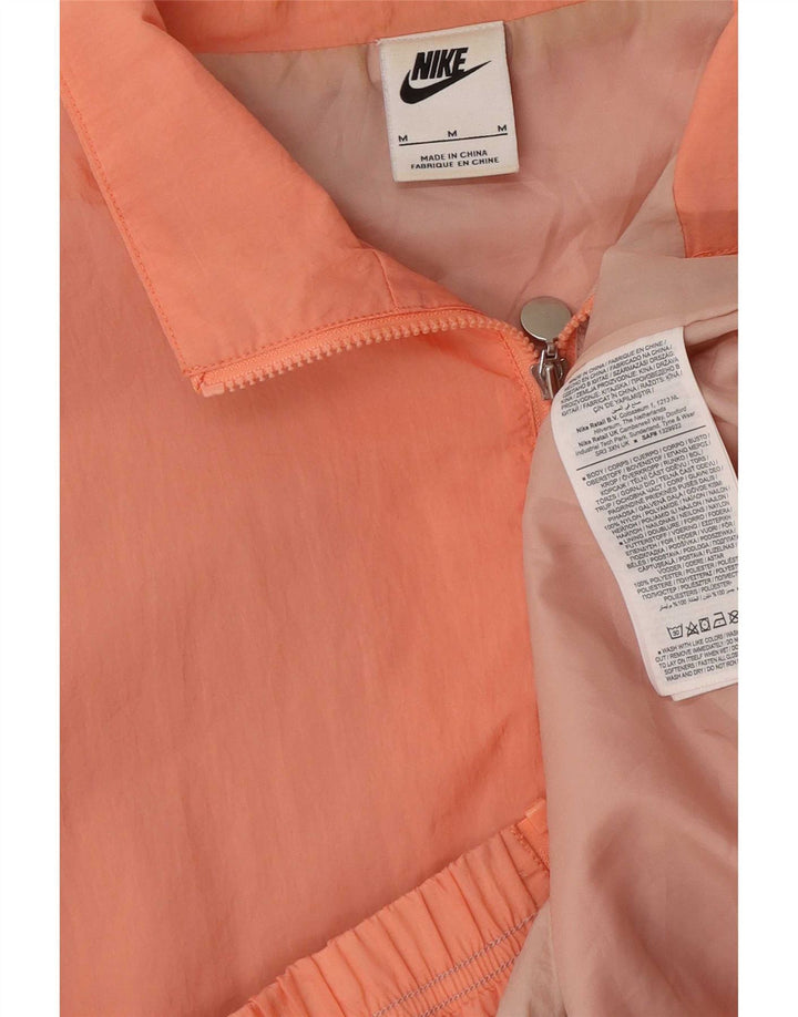 Nike Chaqueta de chándal extragrande con gráfico color block en rosa medio