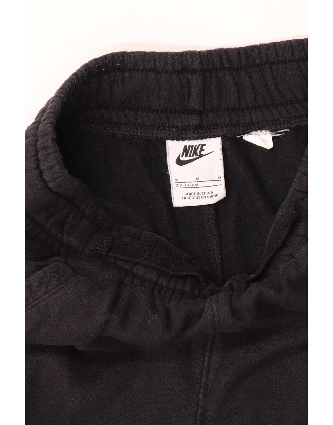 Nike Pantalones de chándal con gráfico para niños, 10-11 años, mediano, negro