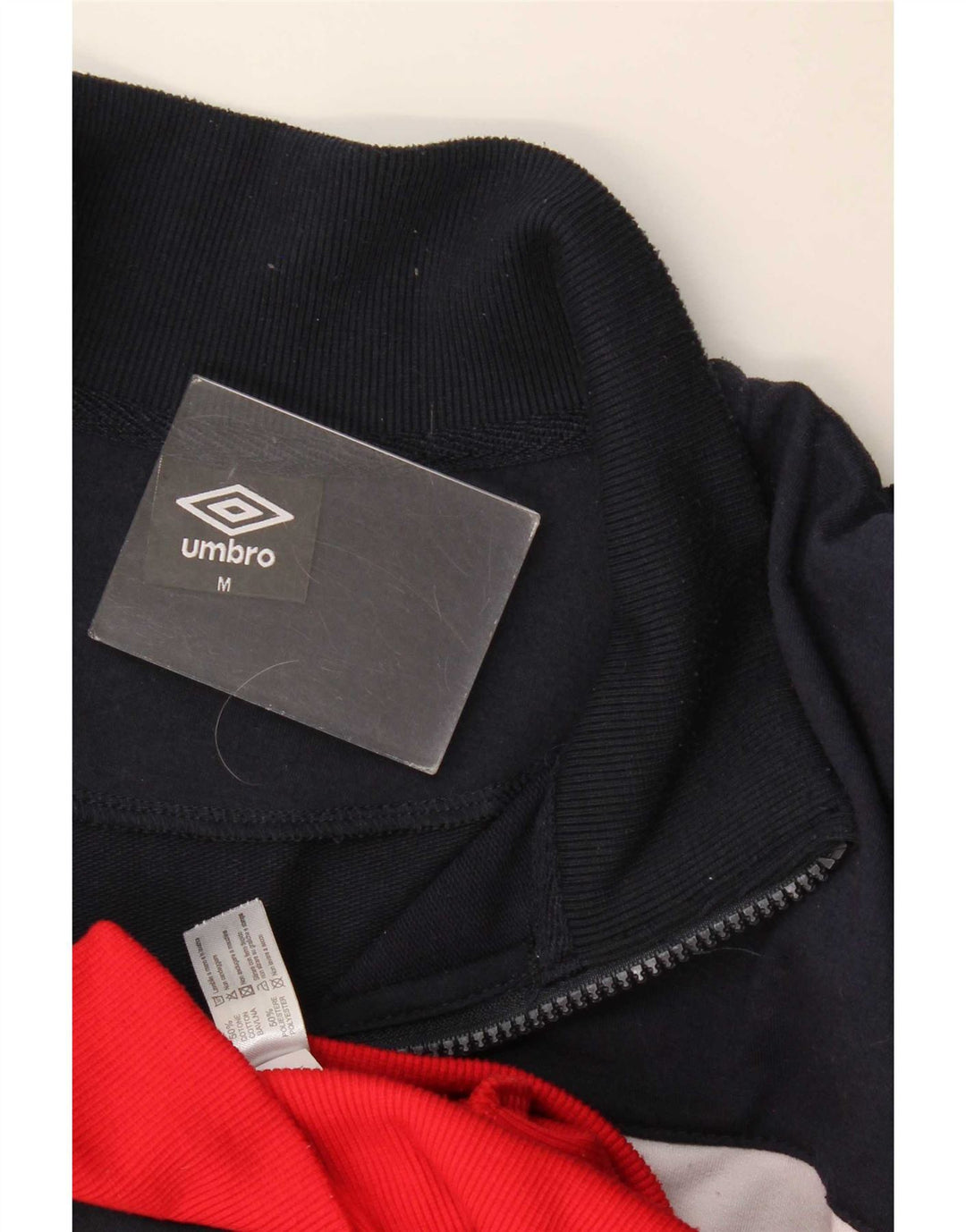 Umbro Chaqueta superior de chándal con estampado gráfico de algodón en bloques de color azul marino mediano