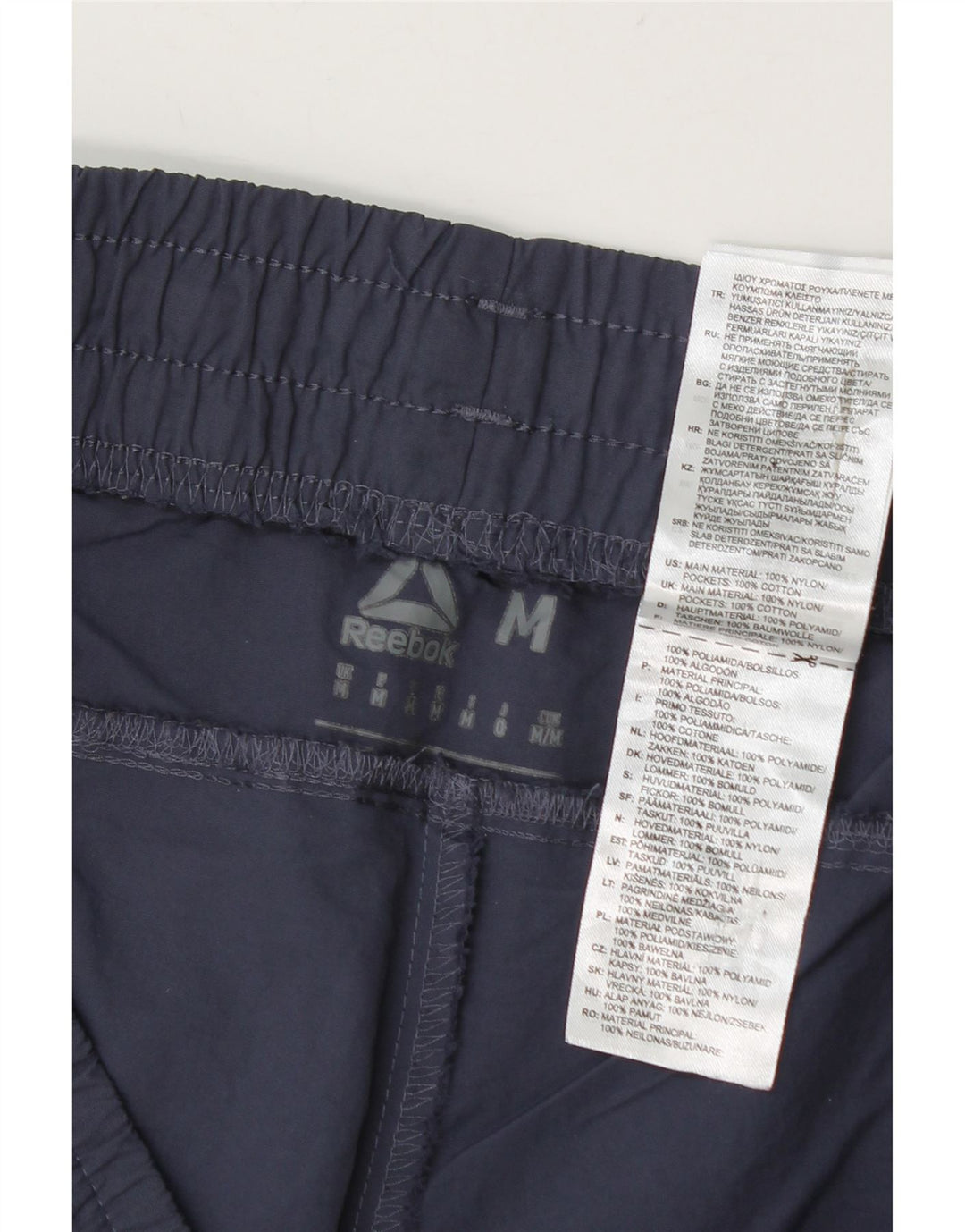 Pantalones cortos deportivos Reebok para hombre de nailon color block en azul marino mediano