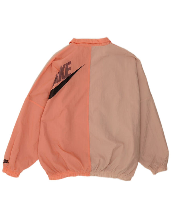 Nike Chaqueta de chándal extragrande con gráfico color block en rosa medio