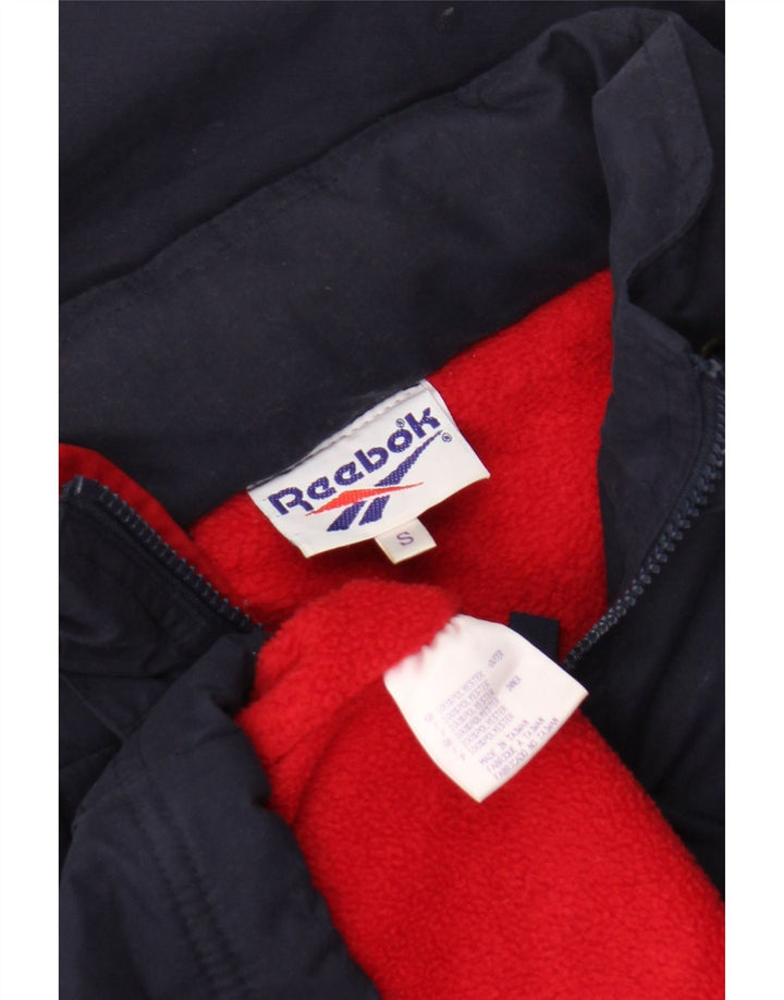 Reebok Chaqueta Anorak de gran tamaño con capucha y gráfico para hombre UK 36 Small Azul marino