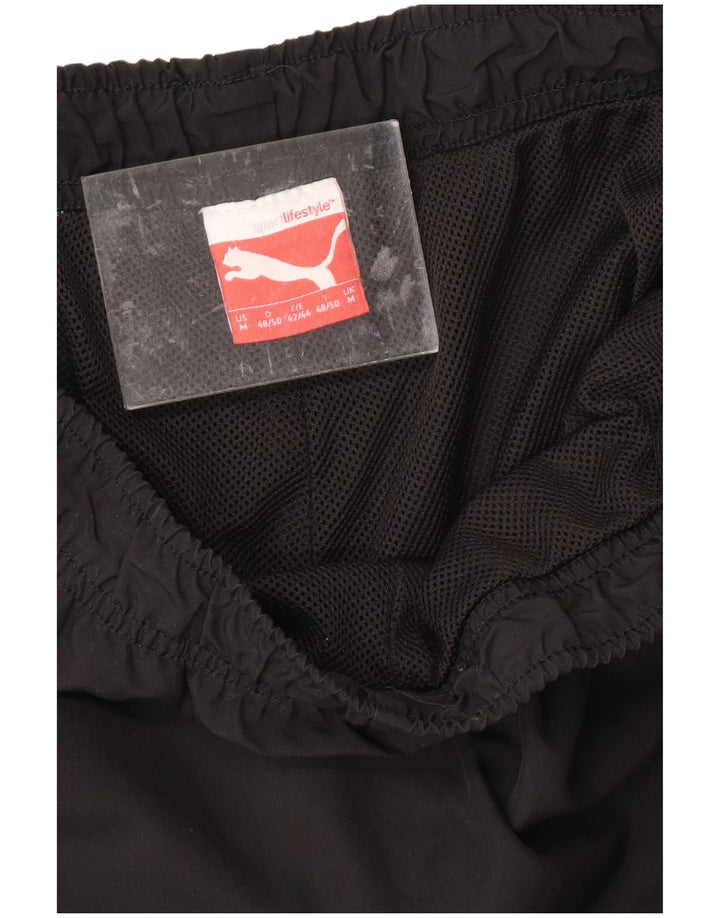 PUMA Pantalones de chándal capri gráficos para hombre, color negro mediano