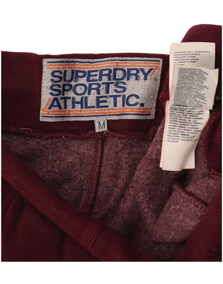 Superdry Hombre Pantalones De Chándal Gráficos Color Block En Burdeos Medio