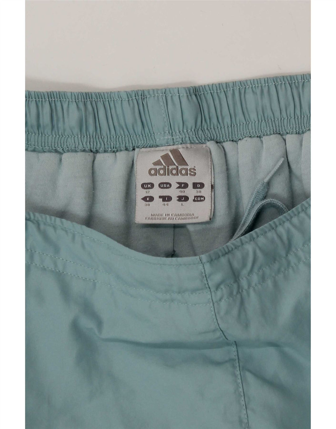 Adidas - Pantalón cortavientos para mujer (talla 40), color azul medio, poliéster