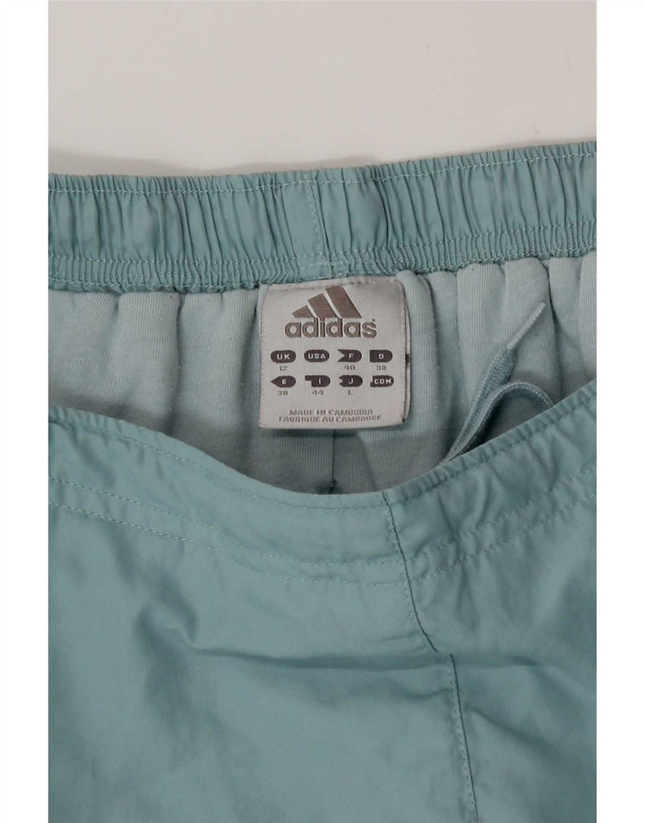 Adidas - Pantalón cortavientos para mujer (talla 40), color azul medio, poliéster